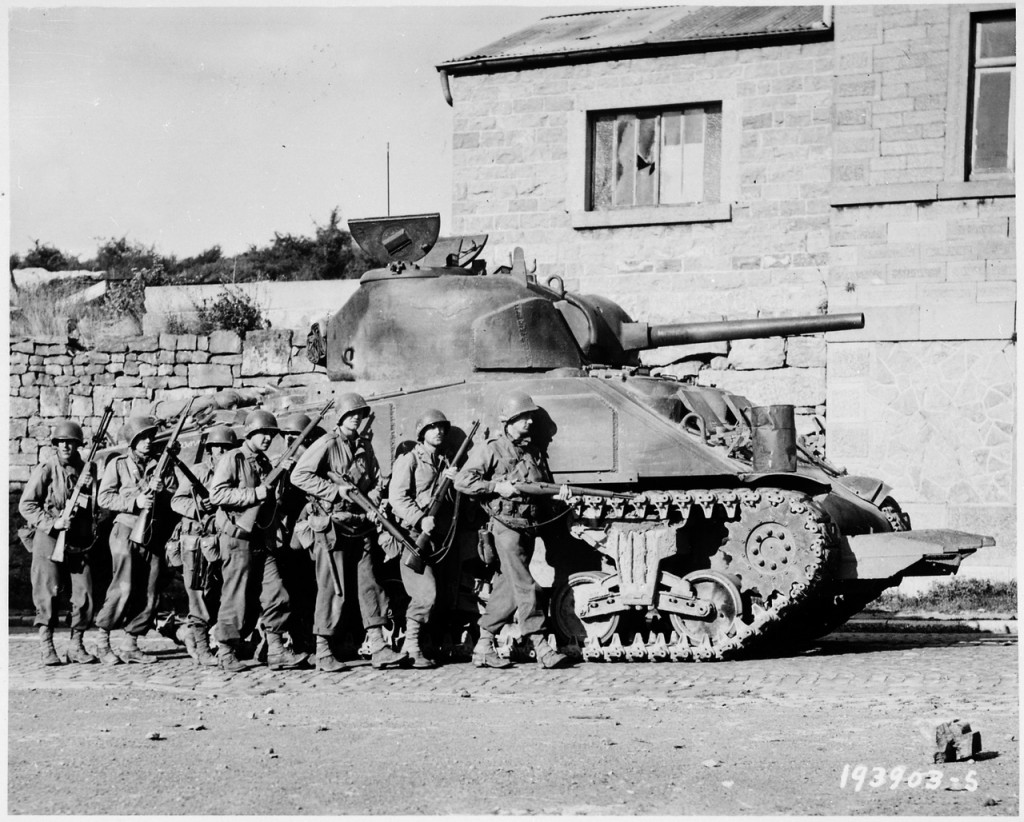 Yanks_of_60th_Infantry_Regiment_advance_into_a_Belgian_town_under_the_protection_of_a_heavy_tank._-_NARA_-_531213.tif